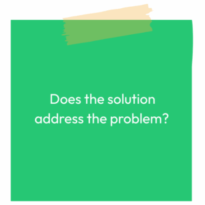 Green sticky note reading: Does the solution address the problem?
